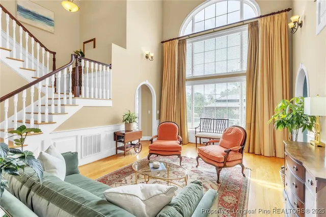 a living room with furniture a fireplace and a large window