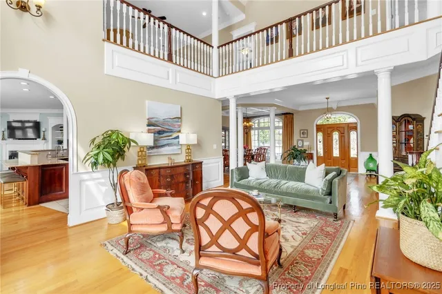 a living room with fireplace furniture and a potted plant