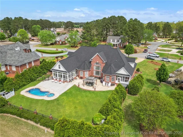an aerial view of a house with outdoor space lake view and mountain view