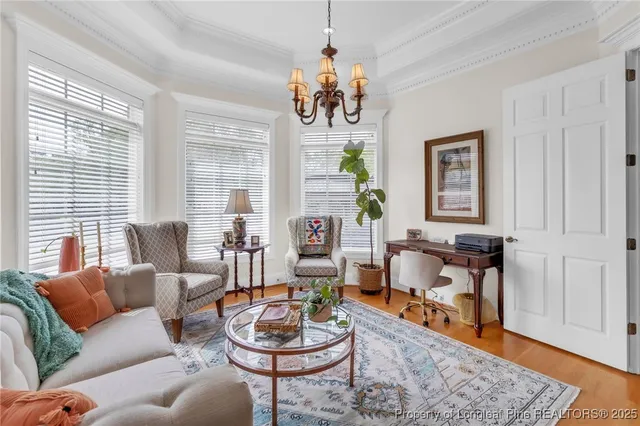 a living room with fireplace furniture and a wooden floor