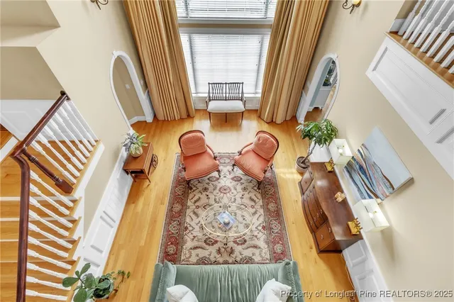 a living room with stainless steel appliances kitchen island granite countertop furniture and a flat screen tv