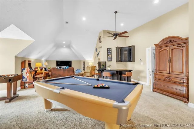 a living room with furniture a flat screen tv and next to a window