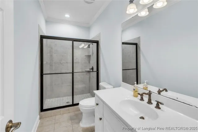 a spacious bedroom with a large bed a chandelier and closet