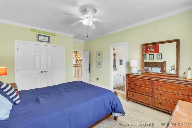 a spacious bedroom with a large bed and a chandelier