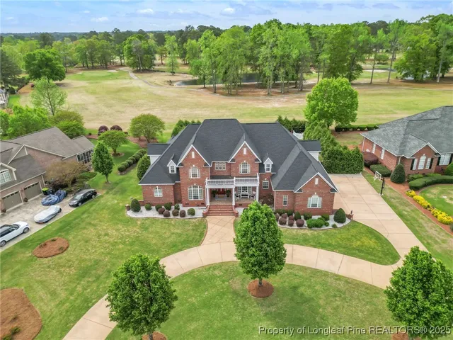 an aerial view of a house with a garden and swimming pool