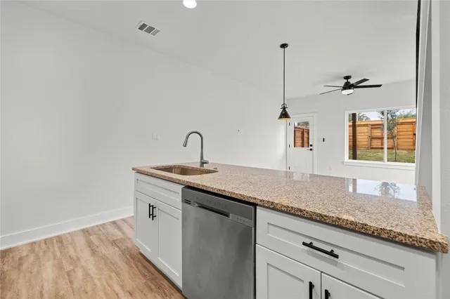 a kitchen with sink stove and cabinets