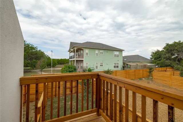 a view of a balcony with wooden fence and floor
