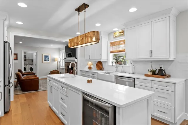 a dining room with furniture a table and kitchen view