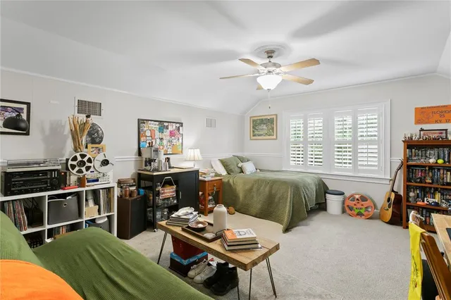 a living room with patio furniture and a floor to ceiling window