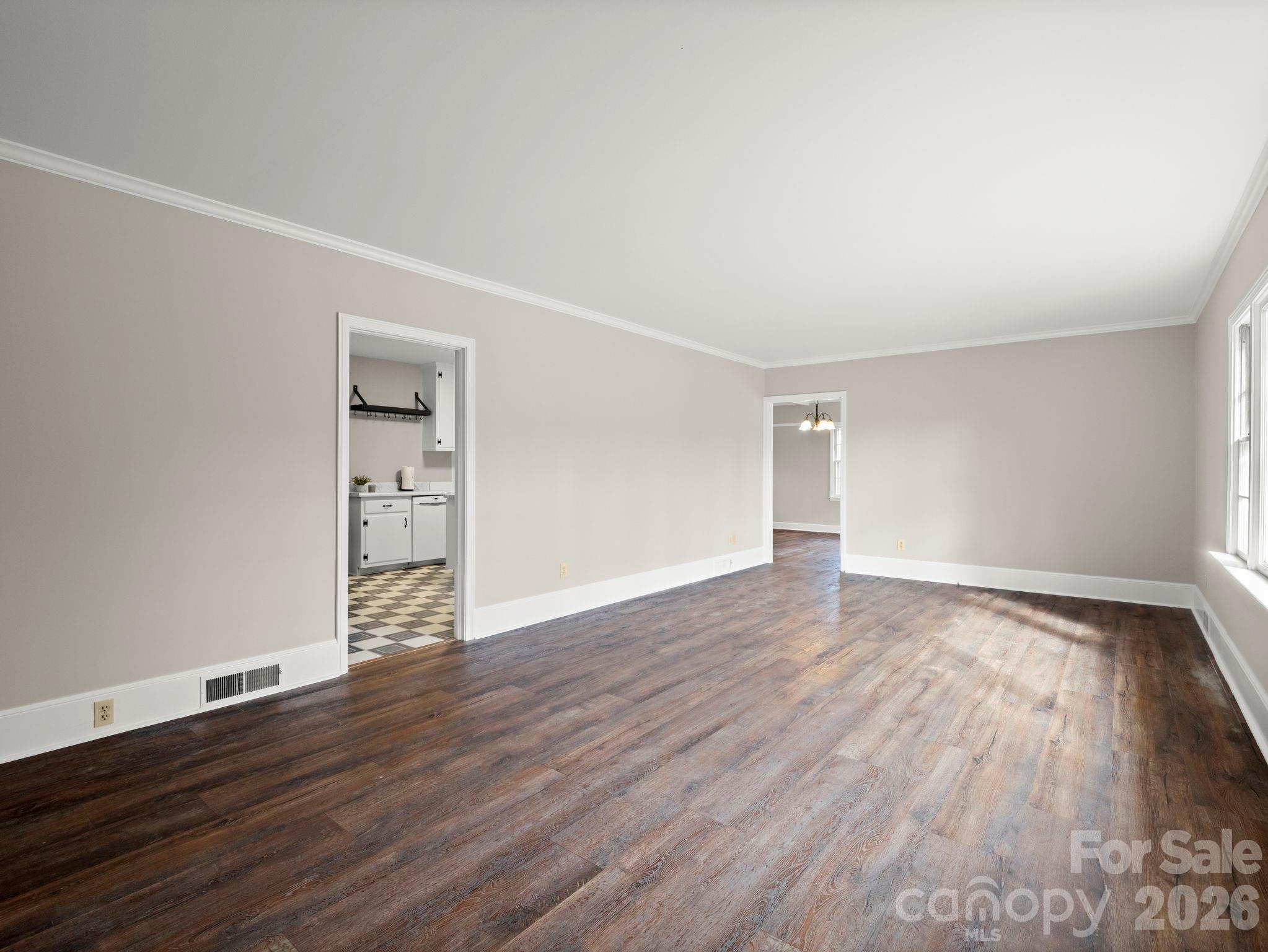 204 West Fernwood Drive Rutherfordton, NC 28139 - Photo 13 of 34 a view of an empty room with wooden floor and a window