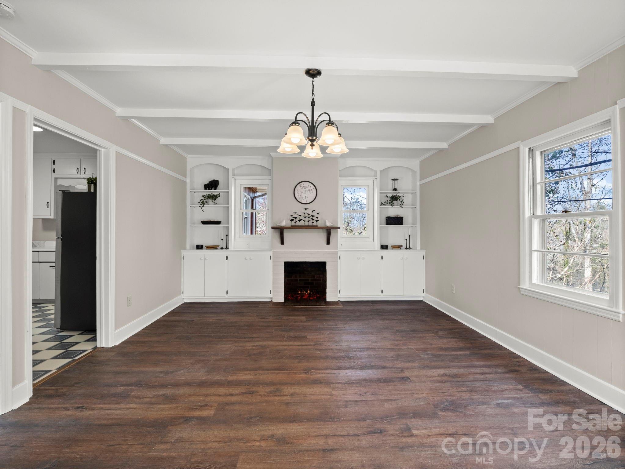 204 West Fernwood Drive Rutherfordton, NC 28139 - Photo 15 of 34 an empty room with wooden floor a fireplace and windows
