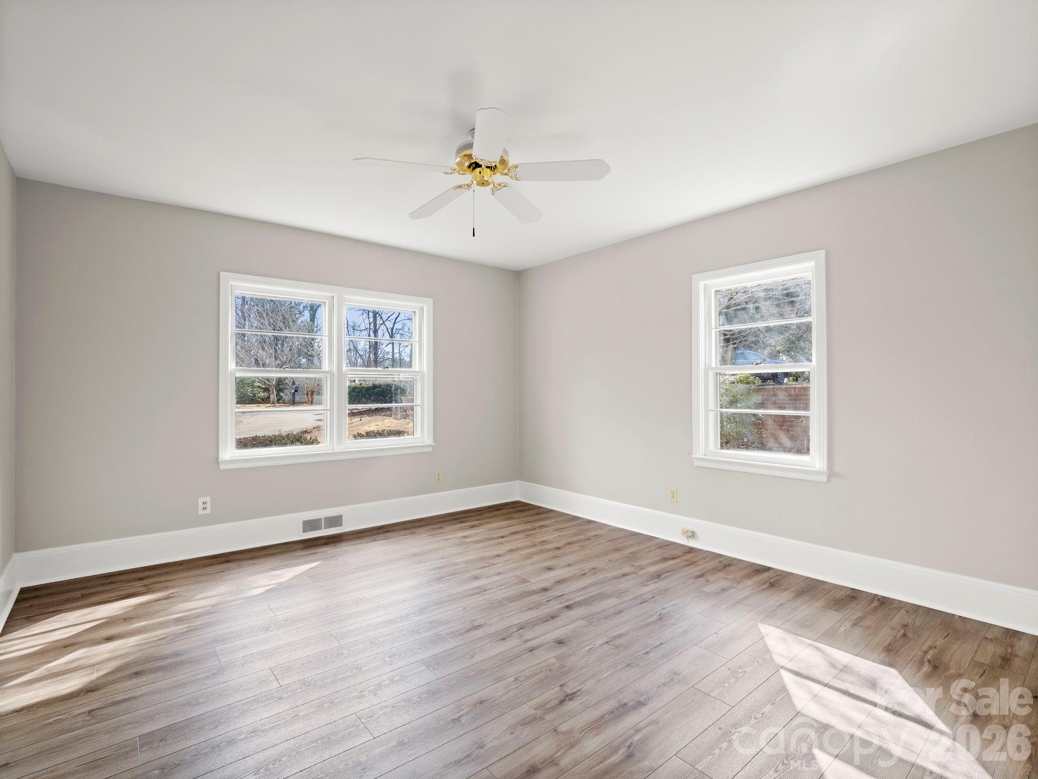 204 West Fernwood Drive Rutherfordton, NC 28139 - Photo 22 of 34 a view of an empty room with wooden floor and a window