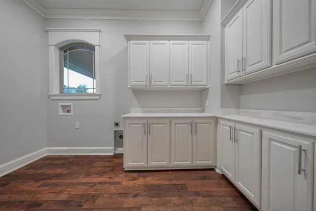 a view of an empty room with closet and a window