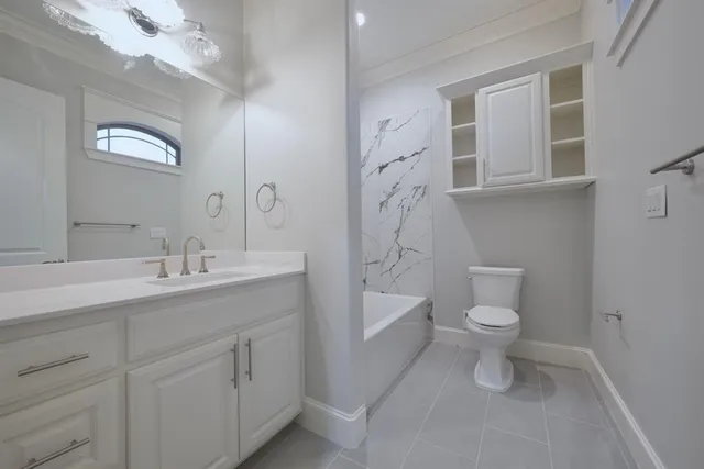 a bathroom with a toilet sink a mirror and shower