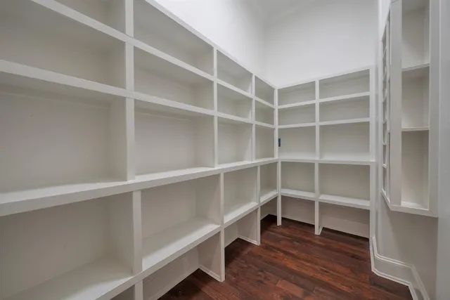 a view of walk in closet with empty racks