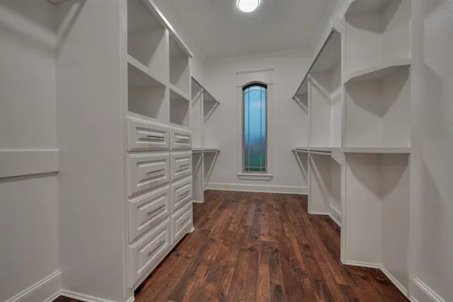 a view of walk in closet with empty racks