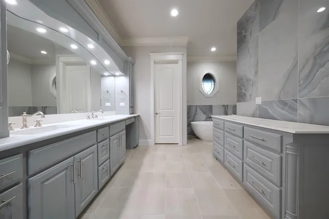 a spacious bathroom with double vanity and mirrors