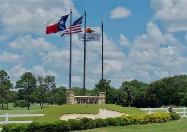 a view of a house with a yard and potted plants