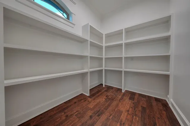 a view of walk in closet with empty racks