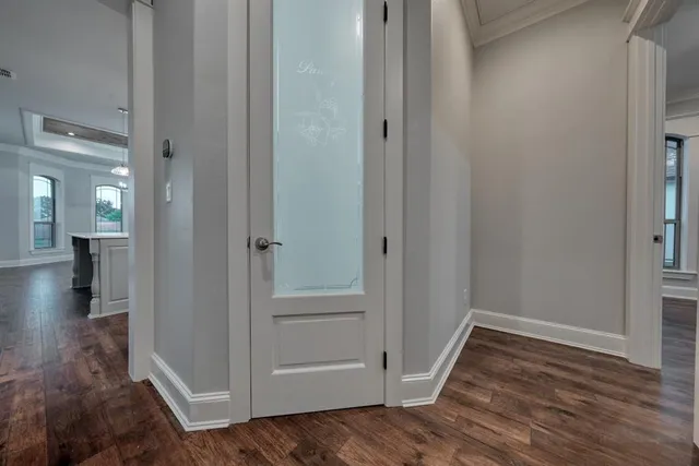 a view of a hallway with wooden floor