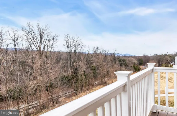 a view of a balcony with wooden fence and floor