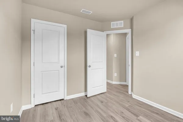 a view of an empty room and wooden floor