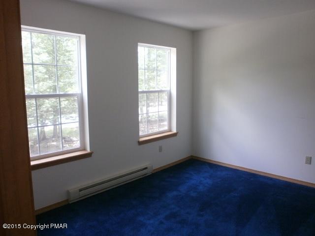 5643 Decker Road Bushkill, PA 18324 - Photo 8 of 12 an empty room with wooden floor and windows