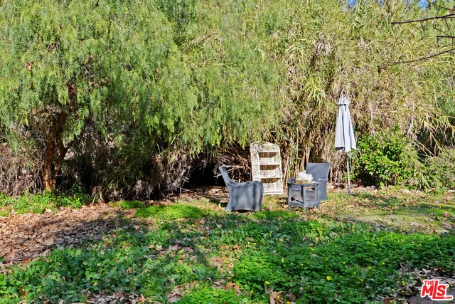 a backyard of a house with table and chairs