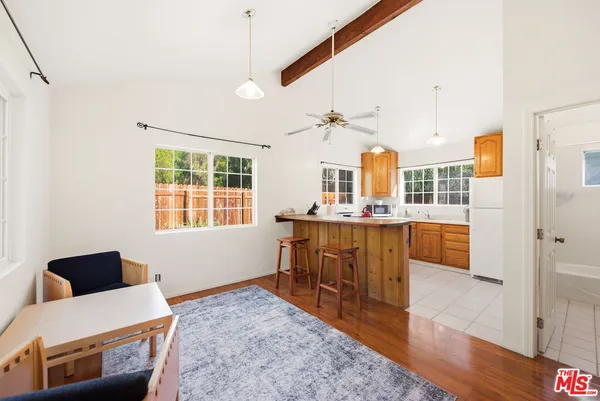 a living room with kitchen island furniture and a wooden floor