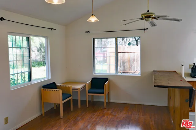 a dining room with wooden floor and a window