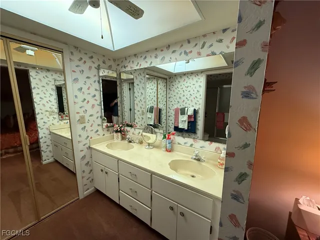 a spacious bathroom with a double vanity sink mirror and shower