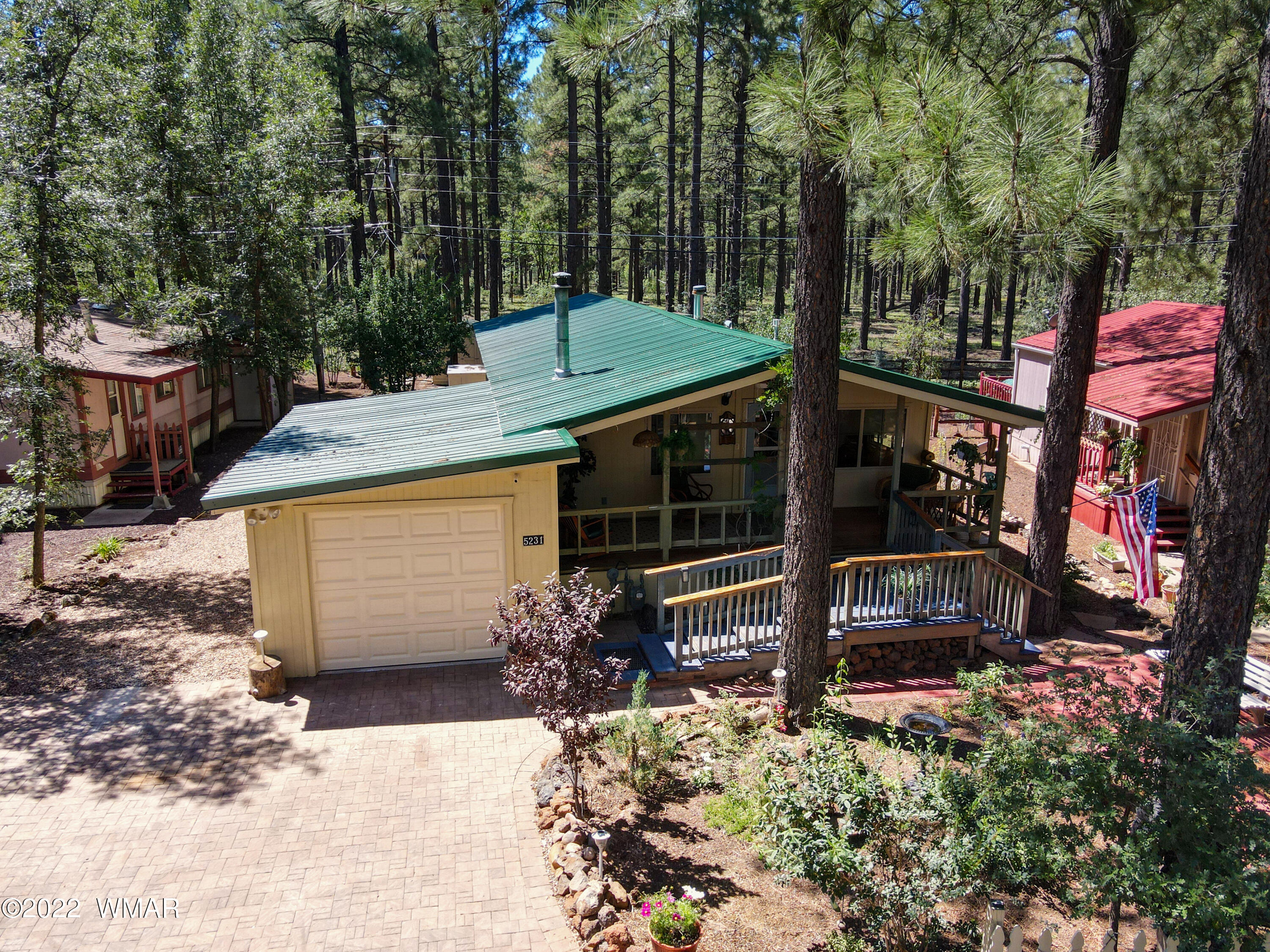 5231 South Blue Ridge Loop Pinetop, AZ 85935 - Photo 1 of 26 a view of a house with a yard and potted plants