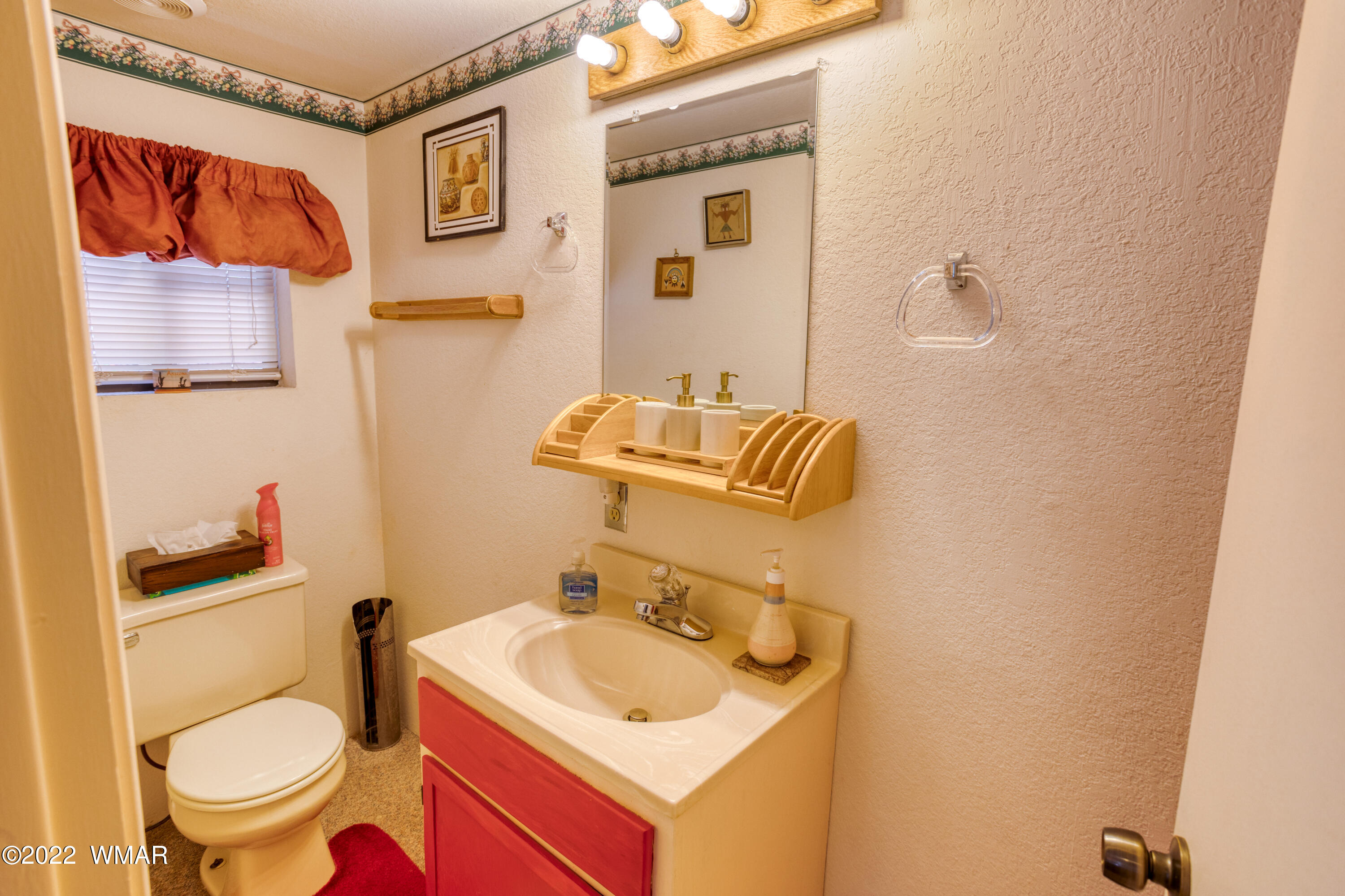 5231 South Blue Ridge Loop Pinetop, AZ 85935 - Photo 13 of 26 a bathroom with a toilet sink and mirror