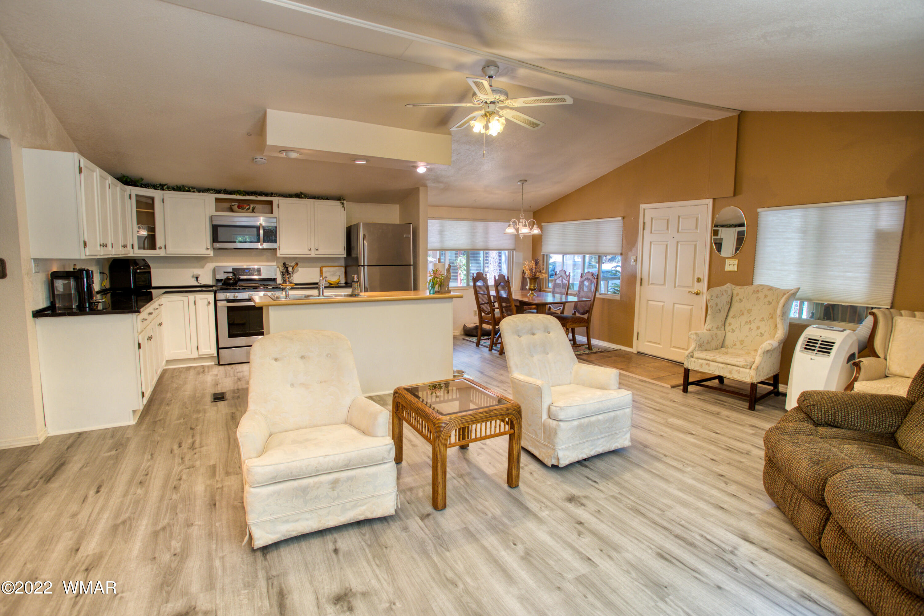 5231 South Blue Ridge Loop Pinetop, AZ 85935 - Photo 4 of 26 a living room with furniture and a chandelier