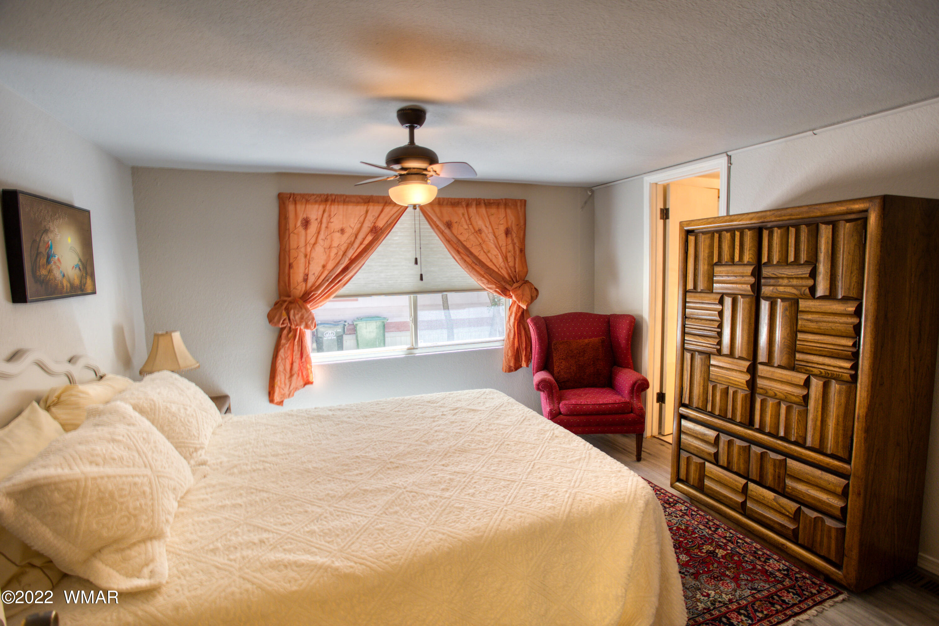 5231 South Blue Ridge Loop Pinetop, AZ 85935 - Photo 9 of 26 a bedroom with a bed and a chandelier