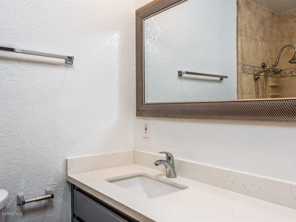 23446 Vía Barra Valencia, CA 91355 - Photo 17 of 42 a bathroom with a sink and a mirror