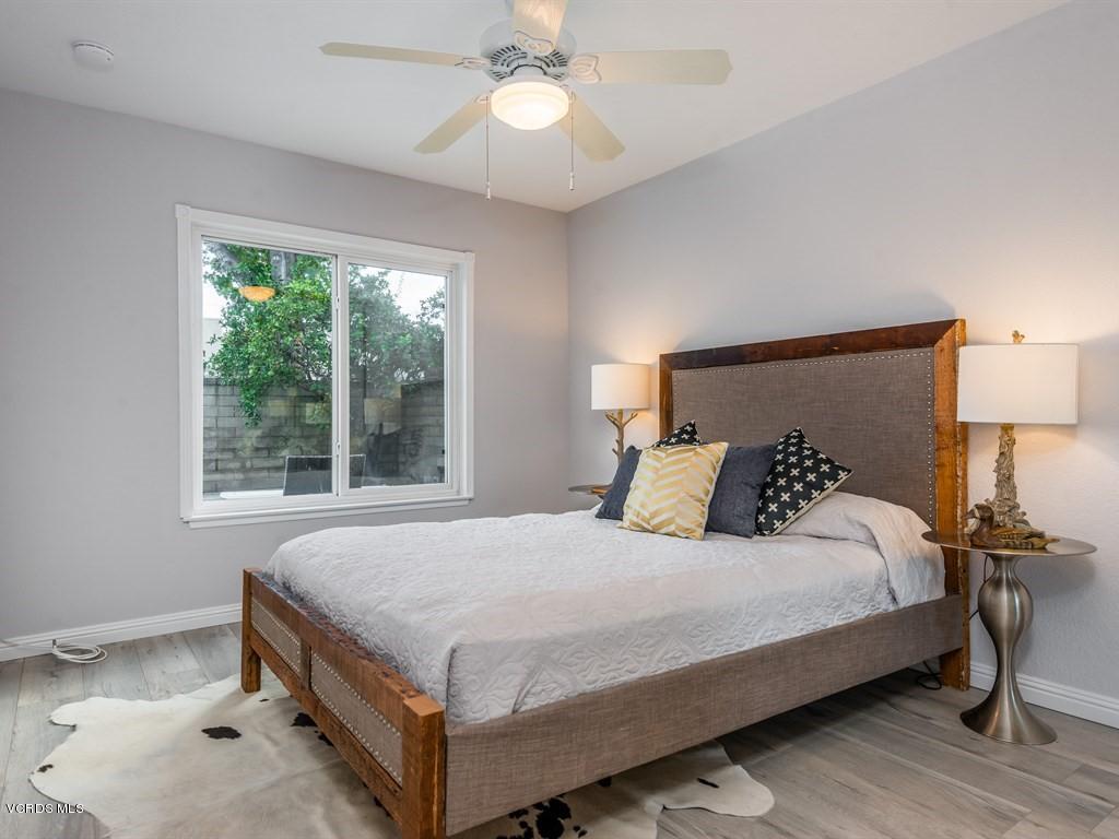 23446 Vía Barra Valencia, CA 91355 - Photo 18 of 42 a bedroom with a bed and a chandelier