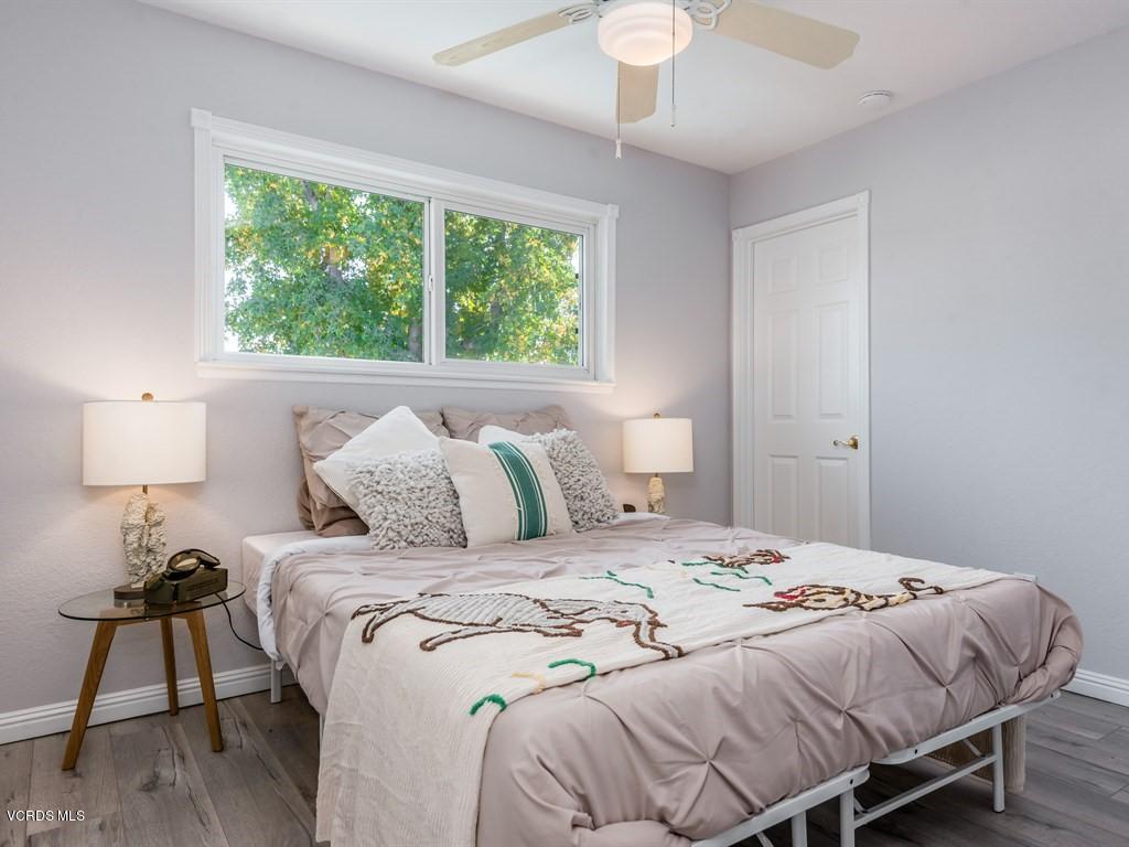 23446 Vía Barra Valencia, CA 91355 - Photo 20 of 42 a bedroom with a bed and a lamp