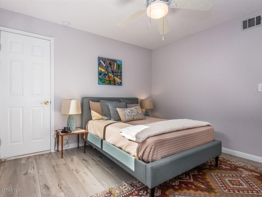 23446 Vía Barra Valencia, CA 91355 - Photo 22 of 42 a bedroom with a bed and a chandelier