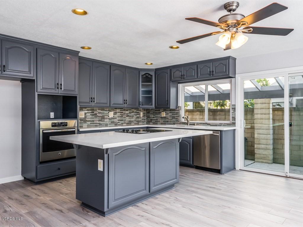 23446 Vía Barra Valencia, CA 91355 - Photo 25 of 42 a kitchen with stainless steel appliances granite countertop a stove and a sink