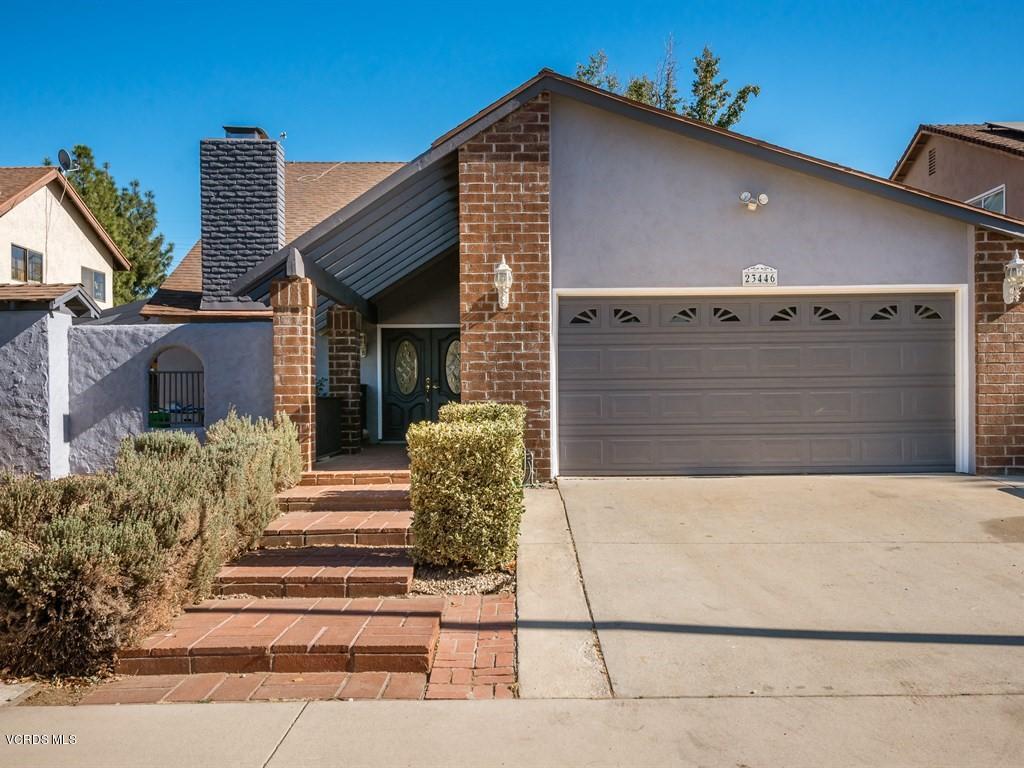 23446 Vía Barra Valencia, CA 91355 - Photo 28 of 42 a front view of a house with a garden