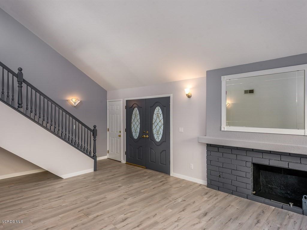 23446 Vía Barra Valencia, CA 91355 - Photo 29 of 42 a view of an entryway with wooden floor and a fireplace