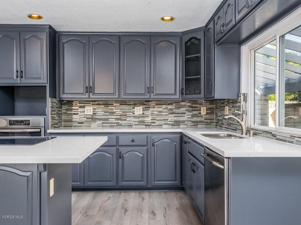 23446 Vía Barra Valencia, CA 91355 - Photo 31 of 42 a kitchen with stainless steel appliances granite countertop a sink stove and cabinets