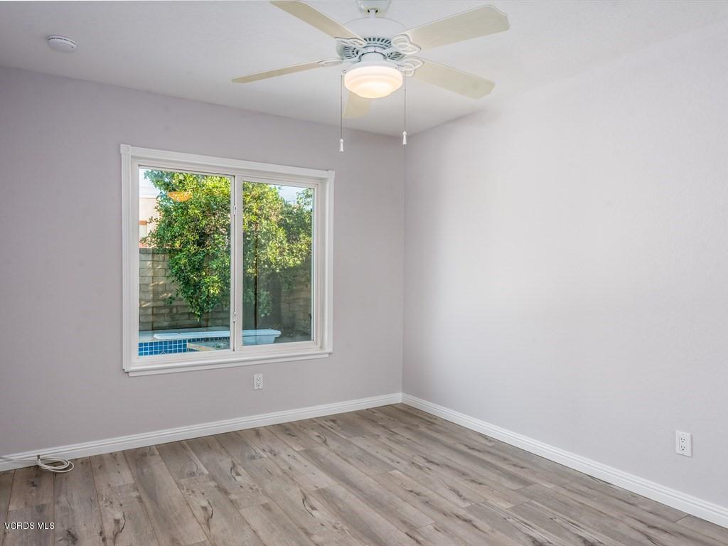 23446 Vía Barra Valencia, CA 91355 - Photo 35 of 42 a view of an empty room with wooden floor and a window