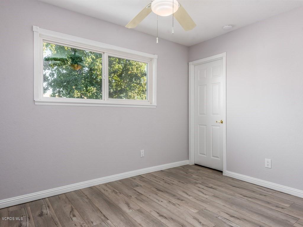 23446 Vía Barra Valencia, CA 91355 - Photo 40 of 42 an empty room with wooden floor and windows
