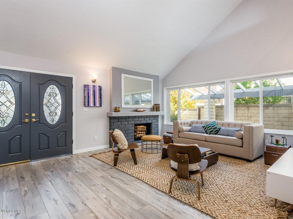 23446 Vía Barra Valencia, CA 91355 - Photo 6 of 42 a living room with fireplace furniture and a large window