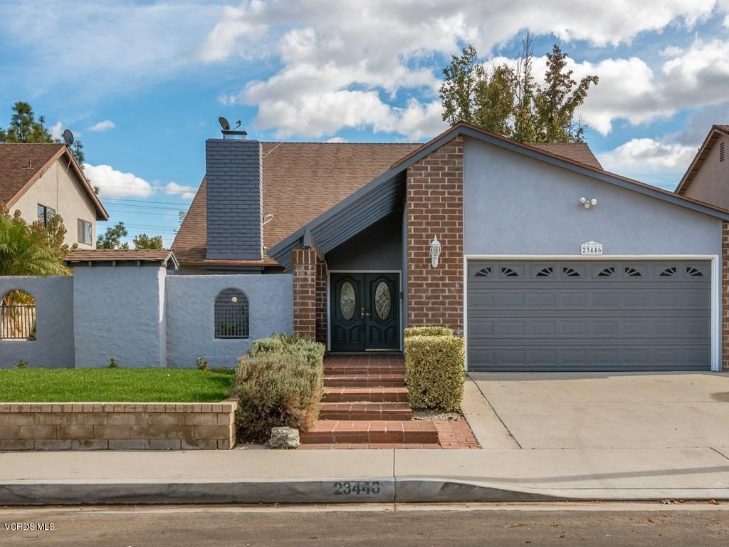 23446 Vía Barra Valencia, CA 91355 - Photo 8 of 42 a view of a house with a garage