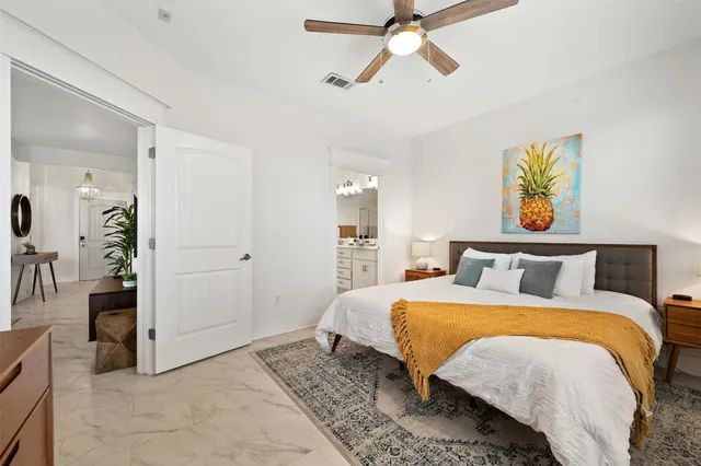 a bedroom with a bed and a chandelier