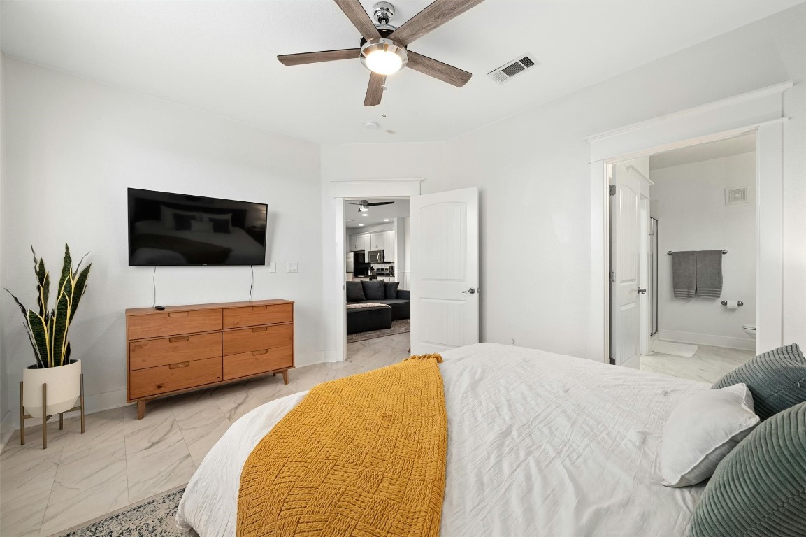 17800 Edgewood Way, Unit 202 Jonestown, TX 78645 - Photo 18 of 40 a bedroom with a bed and a flat screen tv