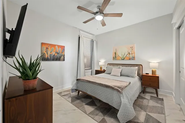 a bedroom with a large bed and a chandelier